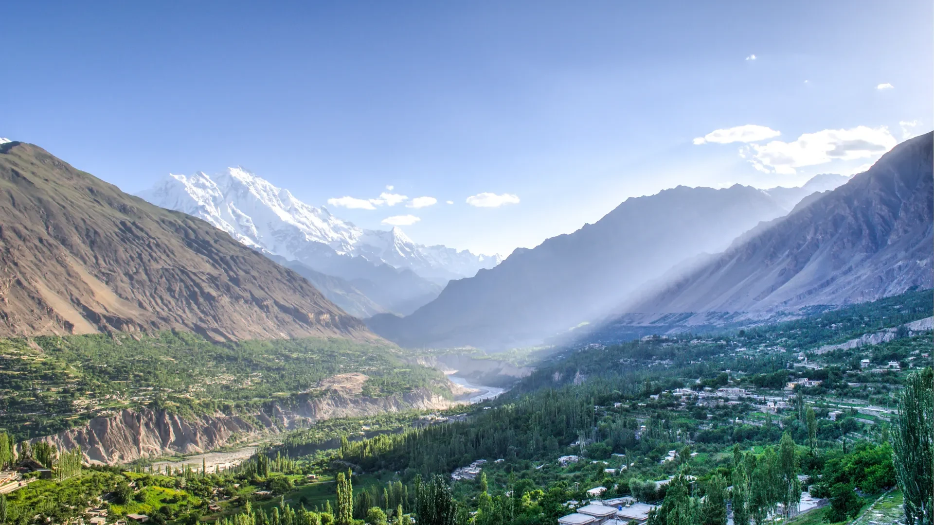 Hunza Valley with terraced villages and snow-covered peaks under a clear sky