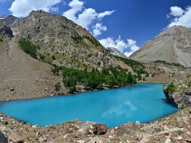 A turquoise lake among rocky slopes in Naltar Valley near Gilgit