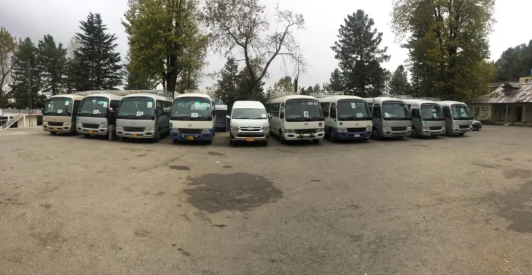 Line of tour coasters parked before departure