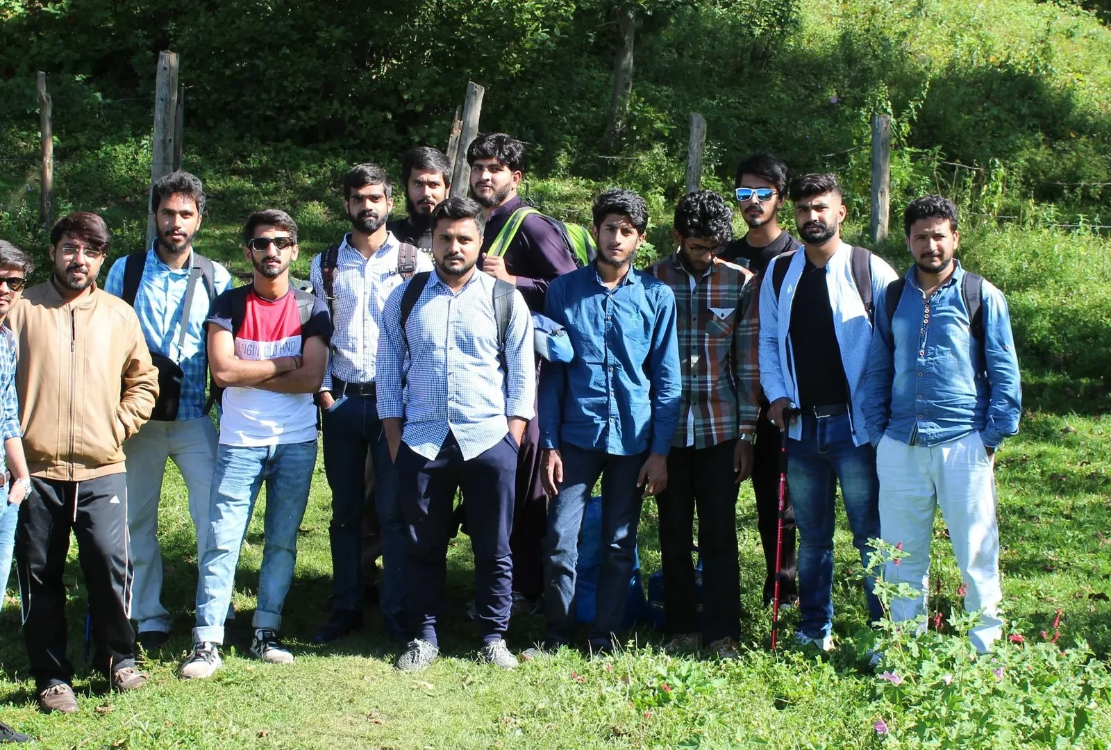 A Venture Tours group trip posing in a mountain meadow