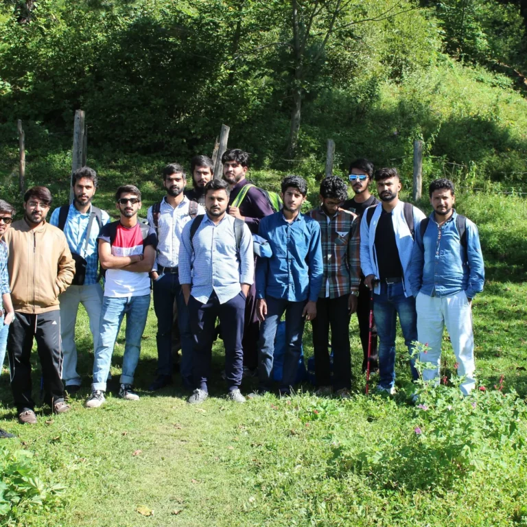 A Venture Tours group trip posing in a mountain meadow