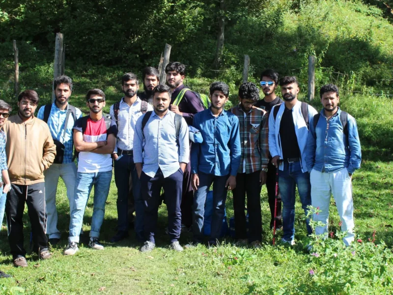 A Venture Tours group trip posing in a mountain meadow