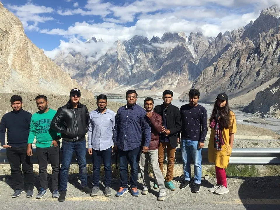 Venture Tours travellers on the Karakoram Highway with the Passu Cones behind
